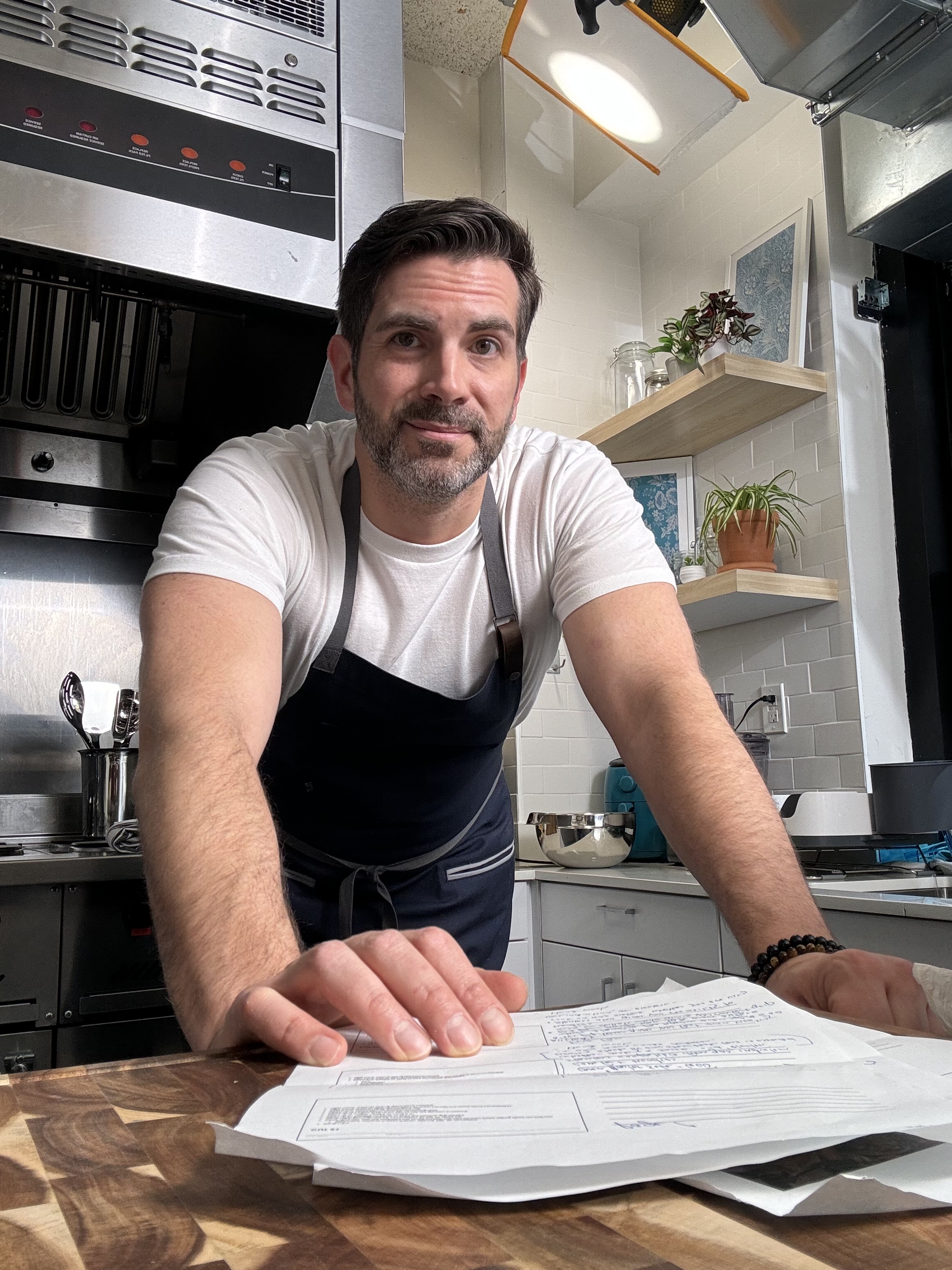 Derek leaning over counter